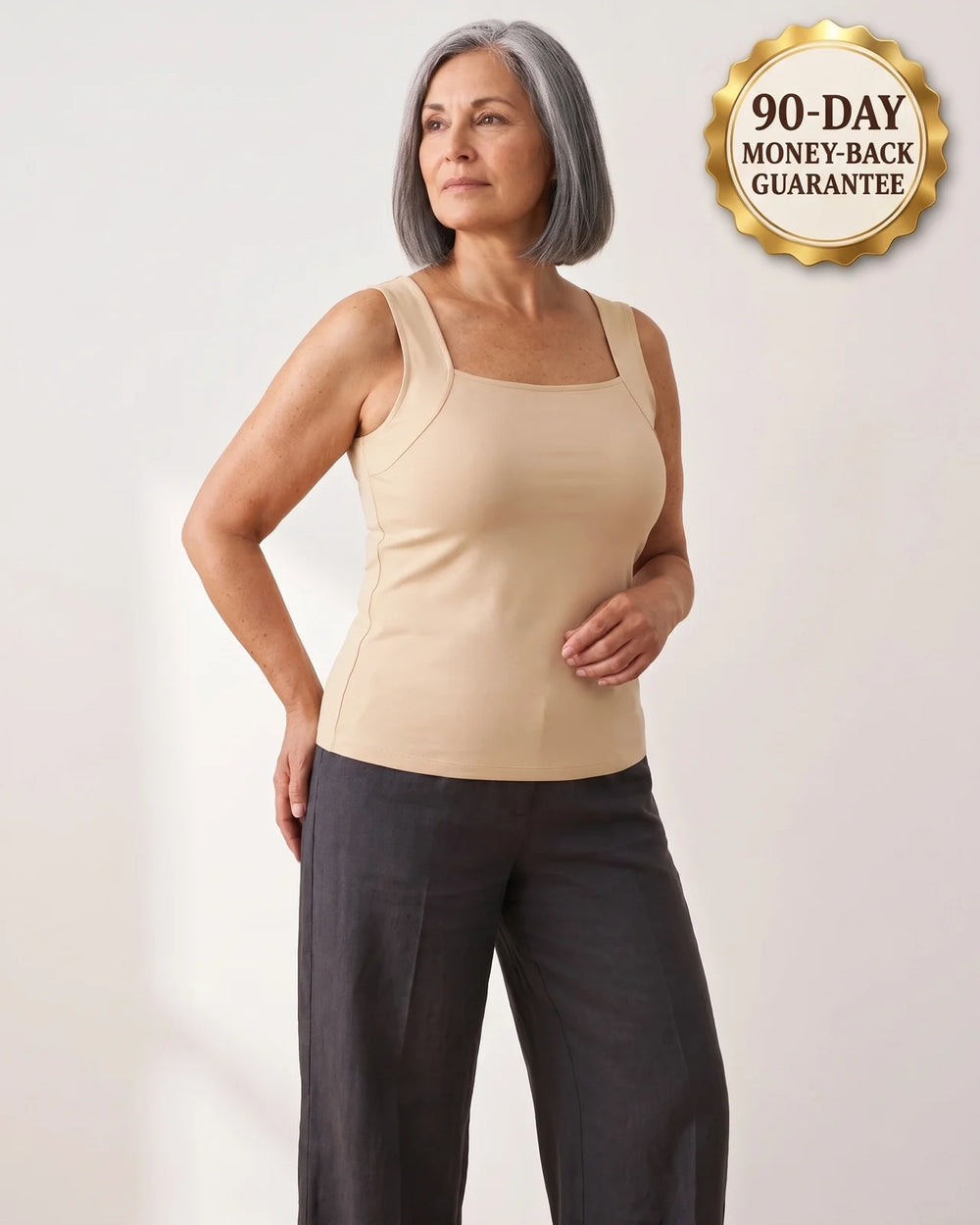 Woman wearing the Maddietanks built-in bra tank in Nude, with a gold 90-day guarantee seal in the corner