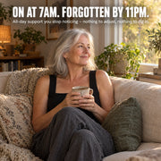 Woman relaxing on a sofa in the Maddietanks built-in bra tank in Black, showing all-day support with nothing to adjust