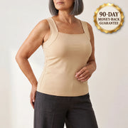 Woman wearing the Maddietanks built-in bra tank in Nude, with a gold 90-day guarantee seal in the corner