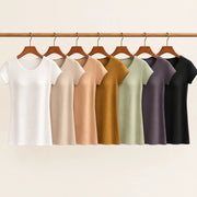 All seven colours of Maddie's built-in bra tee hanging on a wooden rail